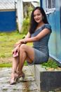 Smiling Woman Sitting and Holding her Phone Posing