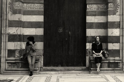 Women Sitting in Front of Building