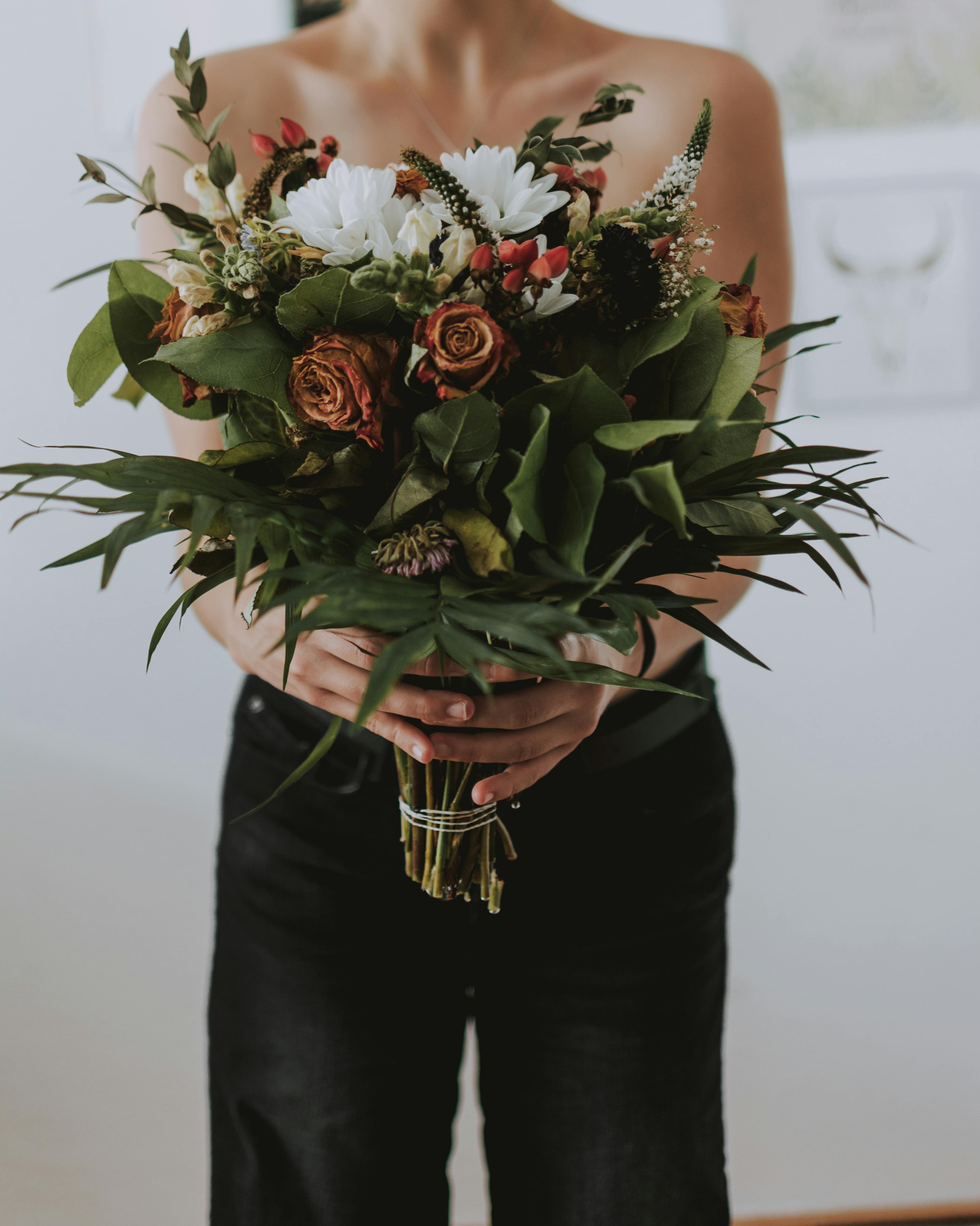 anonymous woman with bunch of flowers