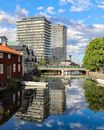 White Boat on River Near Green Trees and Buildings