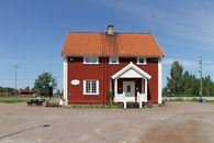 Red and White Wooden House Near Green Trees Under Blue Sky