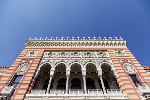 Free Ornate facade of Sarajevo City Hall showcasing historic architecture against a clear blue sky. Stock Photo