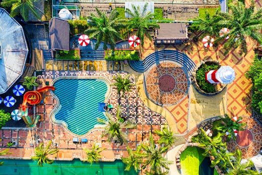 Colorful aerial view of a water park in Banten, Indonesia, featuring pools, slides, and tropical vegetation.