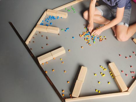 Boy Playing with Colorful Beans