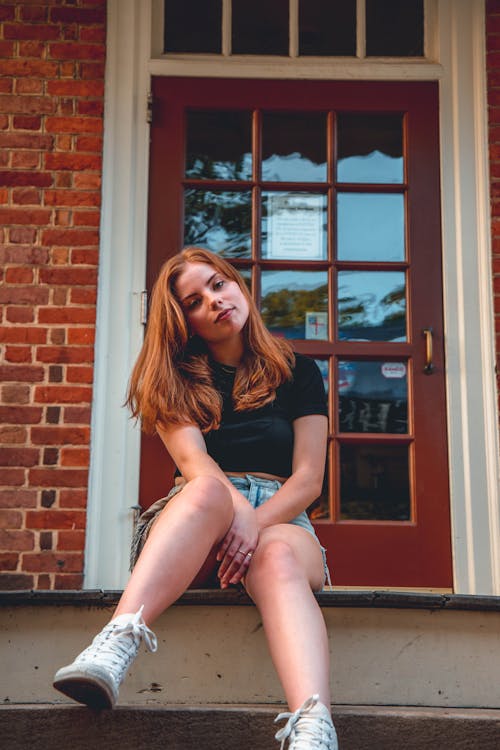 Free Teenage Girl Sitting on Front Porch of House Stock Photo