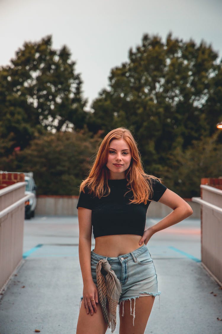 Adolescent Girl Posing In Black Top And Jeans Shorts