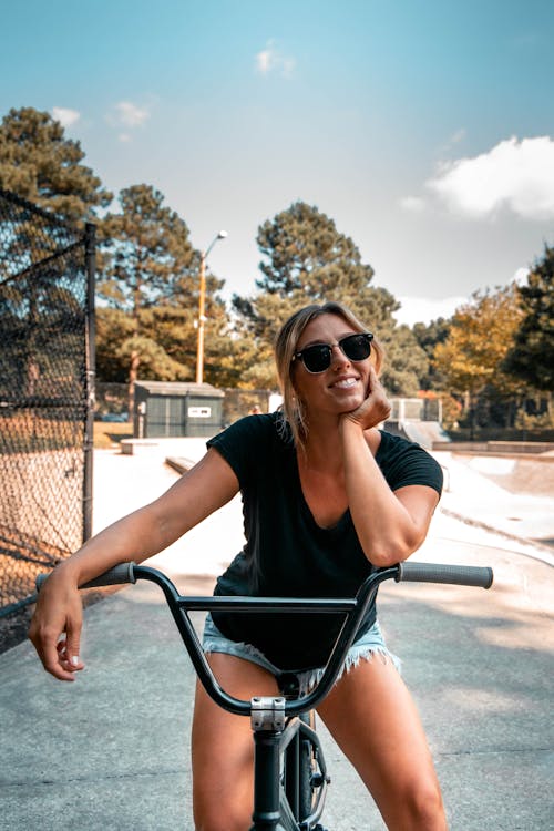 Free Woman Sitting on a BMX Bike and Smiling  Stock Photo