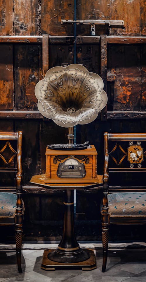 Antique Gramophone on a Table Between Chairs