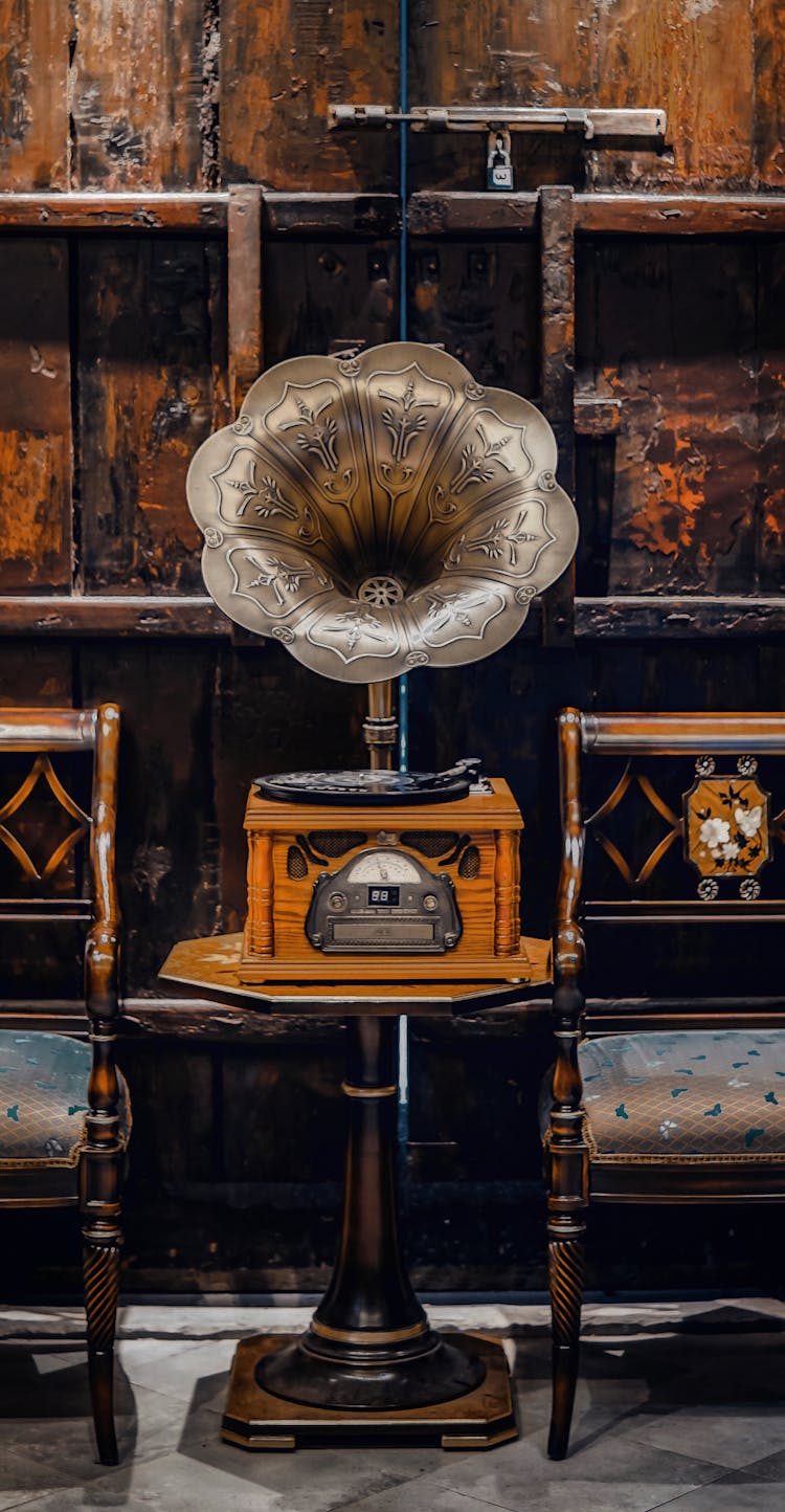 Antique Gramophone On A Table Between Chairs