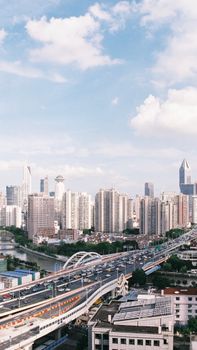 A bustling cityscape showcasing skyscrapers and a busy transportation system under clear skies.