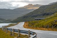 Highway Going Through Mountains by Lake