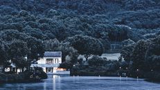 White and Brown Building Near Green Trees and River