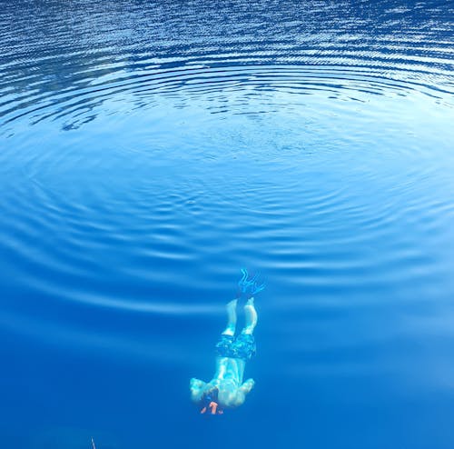 Free Man Diving in Water Stock Photo