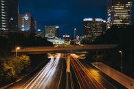 Light Streaks of Cars Driving under a Bridge in the City at Night