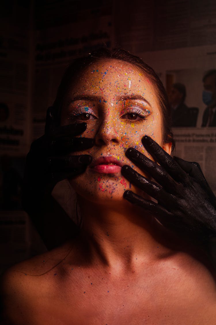 Woman With Black Hands On Her Face