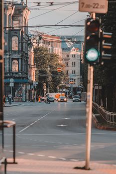 A view of a historic street in Riga, Latvia with traffic lights and classic architecture.