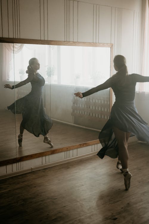 Woman Dancing Ballet Gracefully Inside Studio