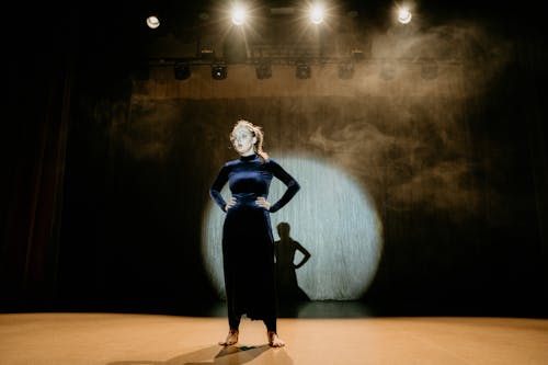 Woman in Velvet Dress Performing on Stage