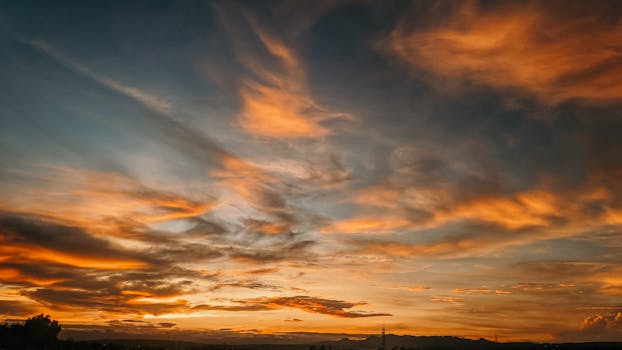 Beautiful sunset with vibrant orange and blue clouds in a scenic skyscape.