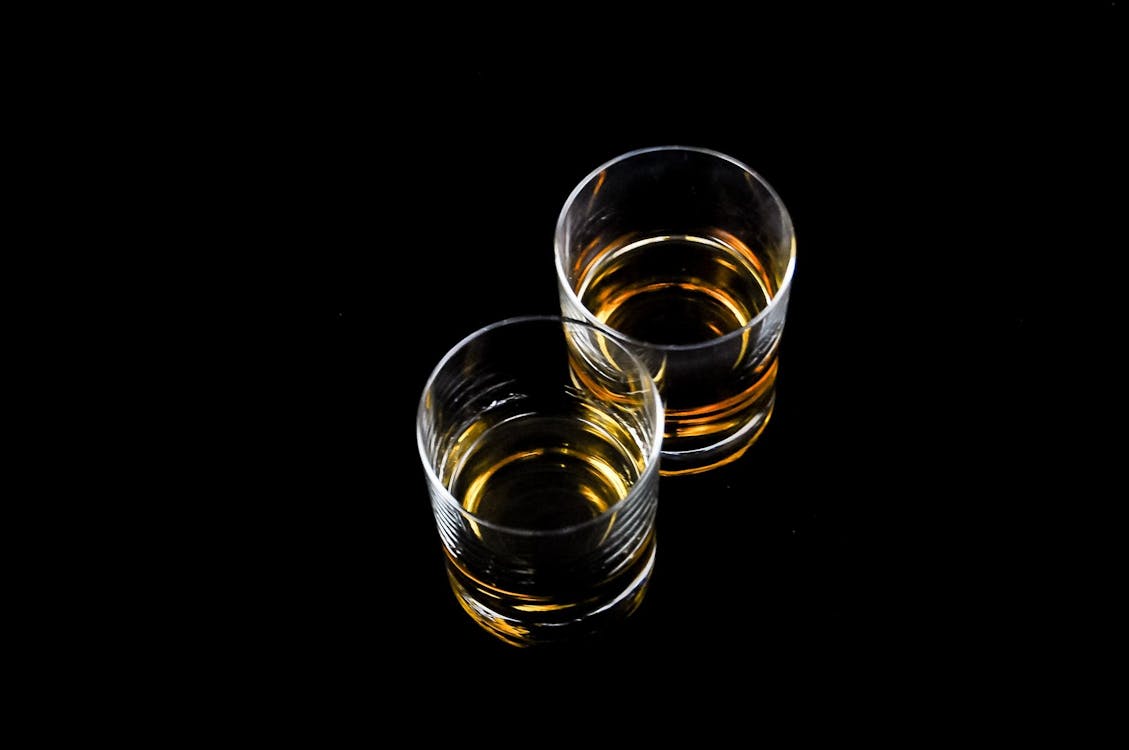Free Two Clear Shot Glasses Filled With Liquors Stock Photo