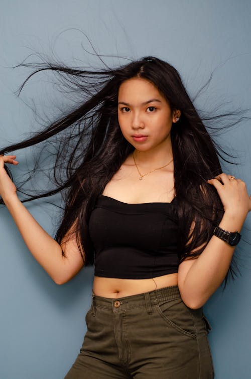 Woman Wearing Black Tank Top Holding Her Hair