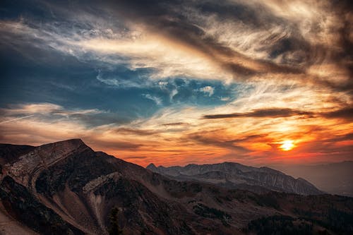 Free Aerial Photography of Mountains Under Orange and White Sky Stock Photo