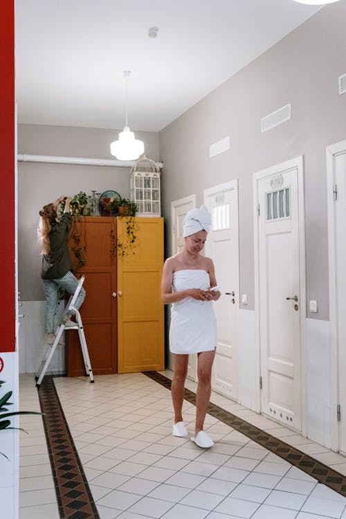 Woman in Bath Towel Walking in a Corridor