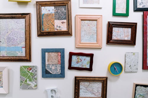 Variety of Maps in Wooden Frames Hanging on Wall