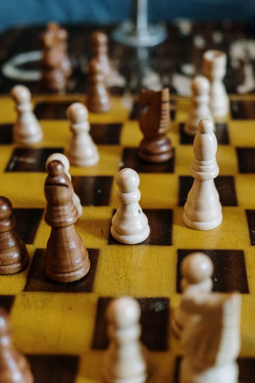Free Close-up shot of a chess game in progress with wooden chess pieces on a board. Stock Photo