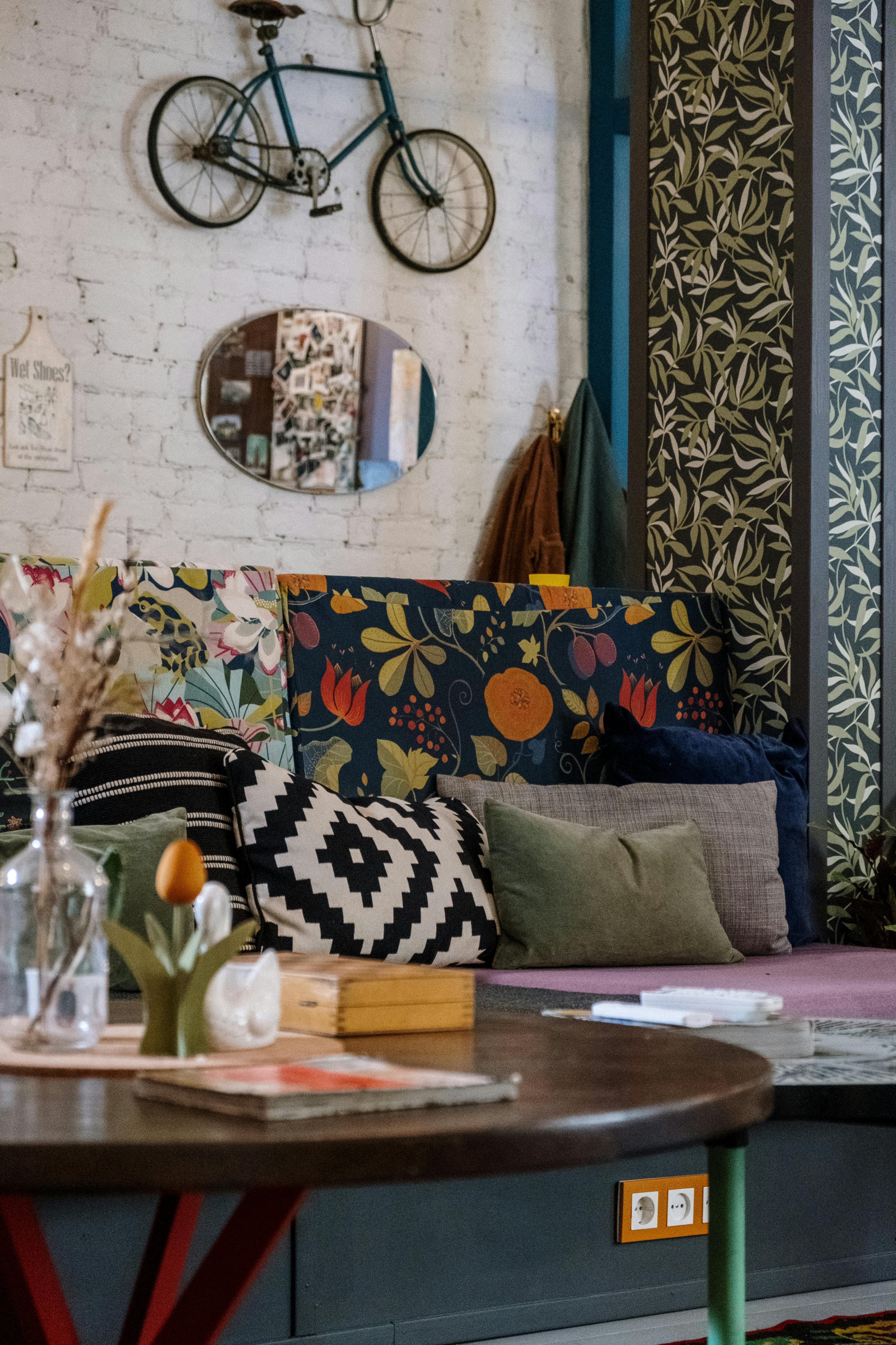 Stylish and cozy room featuring a floral sofa and decorative bicycle wall art, perfect for interior enthusiasts.
