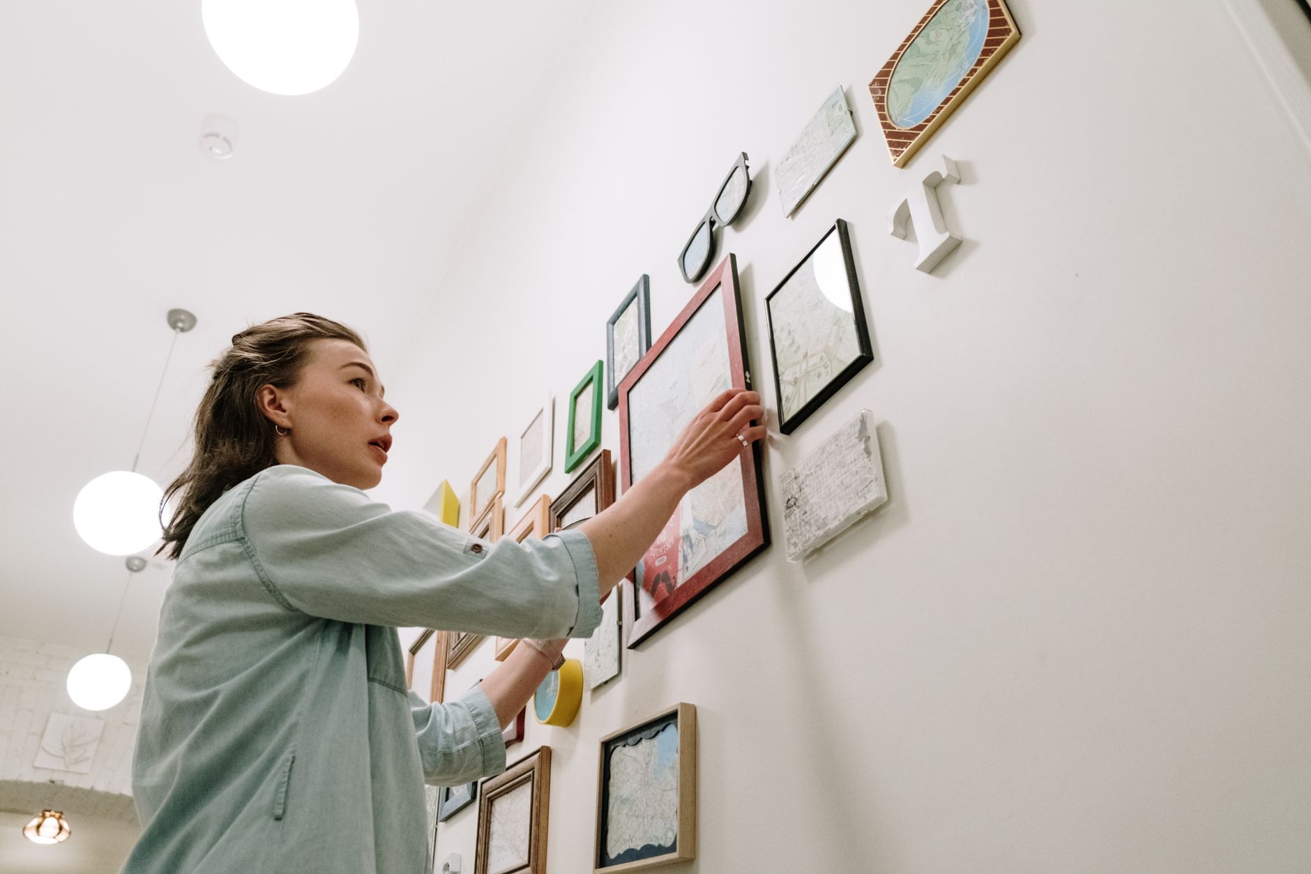 Picture frame being aligned on a wall with a level