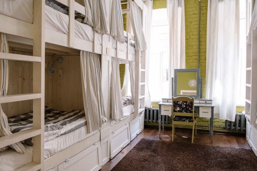 Comfortable hostel dorm room with clean bunk beds and a cozy ambiance.