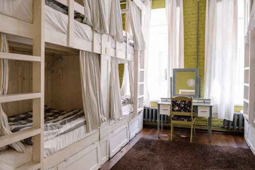 Free Comfortable hostel dorm room with clean bunk beds and a cozy ambiance. Stock Photo