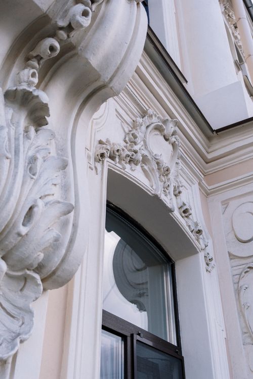 Free Close-up of an ornate marble window on a classic architectural facade, highlighting intricate design details. Stock Photo