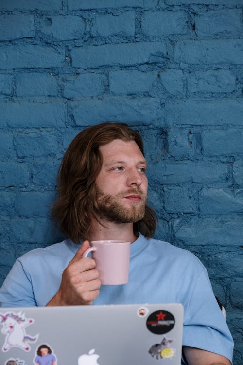 A Bearded Man Holding a Ceramic Mug