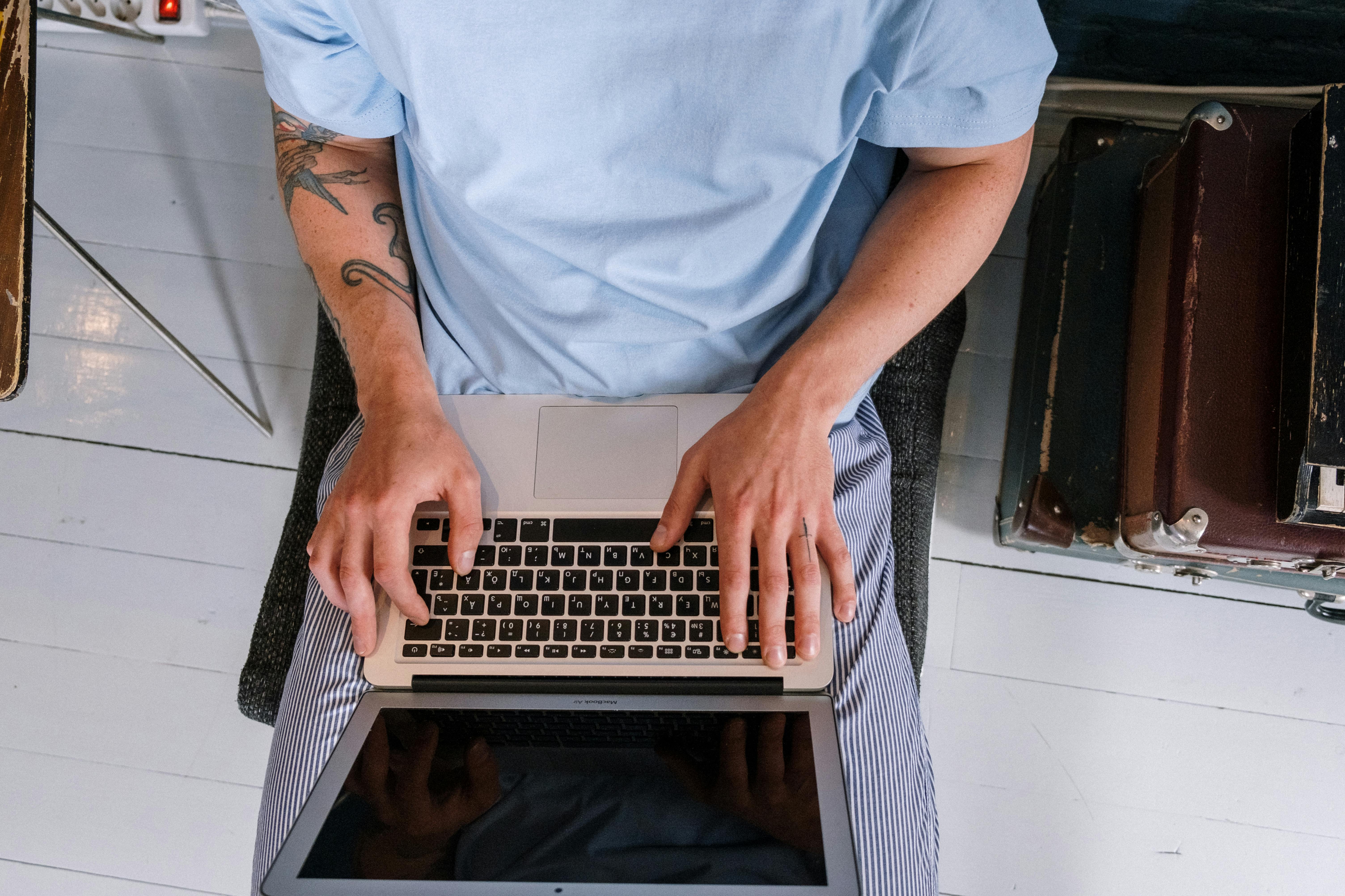 High Angle Shot of a Person Using Laptop