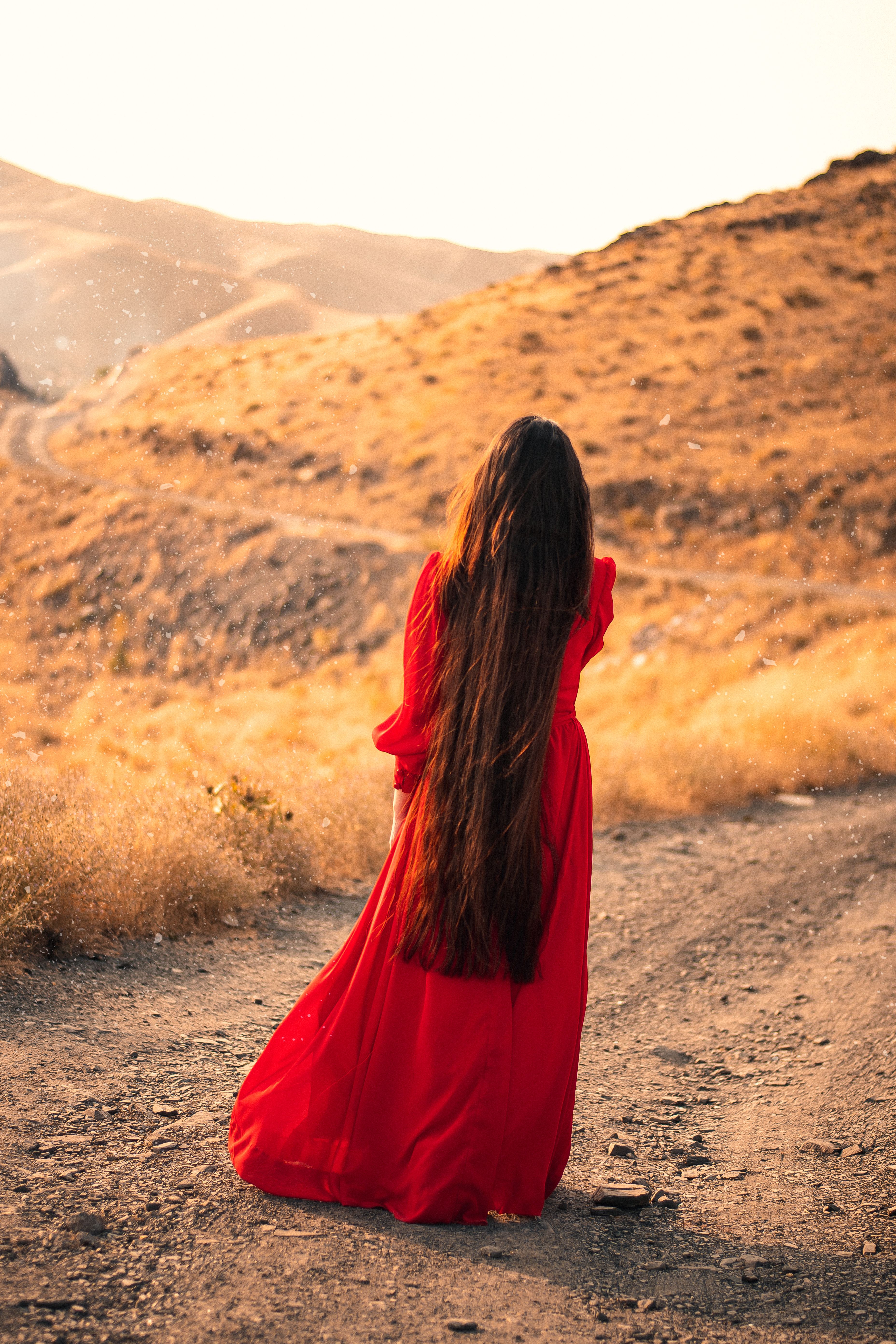 Woman in Red Dress Standing on Dirt Road · Free Stock Photo