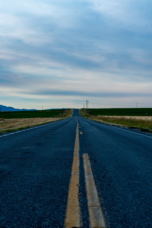 Free Empty road stretching through vast countryside landscape near Newton, Utah. Stock Photo