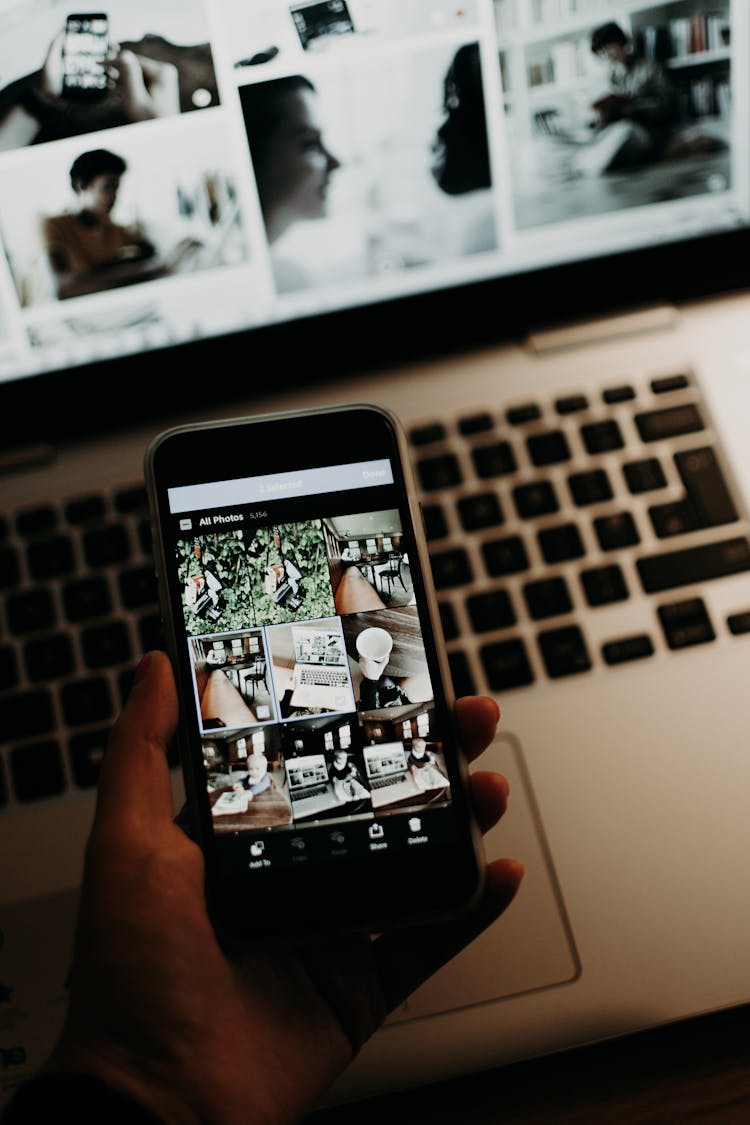 Close-up Of A Person Looking At Photos On A Smartphone 