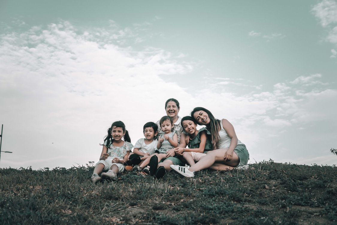 A Latino family gathered together outdoors