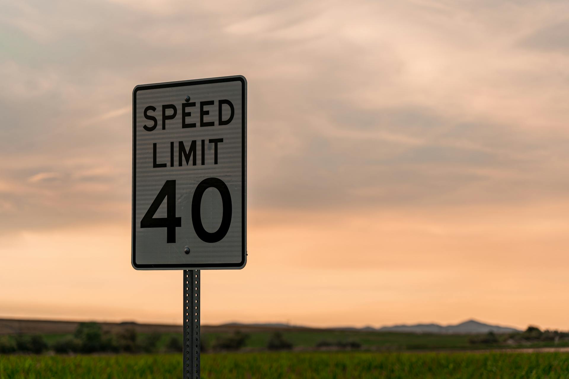 Captivating speed limit sign against a rural Utah sunset sky.