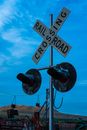 A Level Crossing Sign Under the Blue Sky