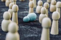 Wooden figures placed among fallen representing concept of breakdown during fight against public opinion and social order