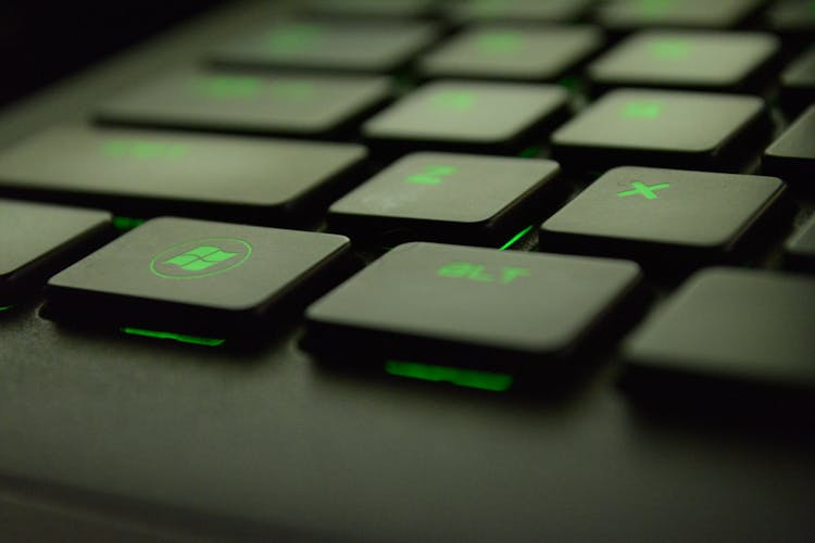 Close-up Photography Of Black And Green Computer Keyboard Keys