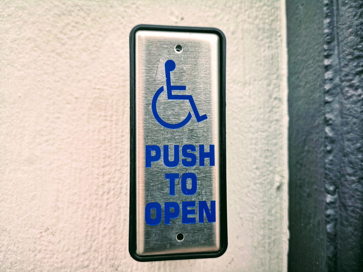 An accessible public toilet facility with grab rails and accessible layout