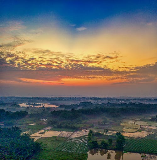 Aerial Photography of a Farmland Under Golden Sky