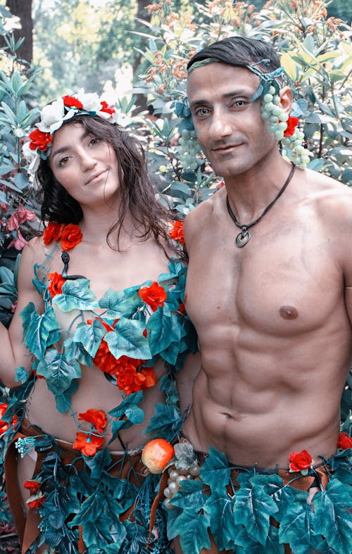 A Man and a Woman with Leaves Costume Looking at the Camera