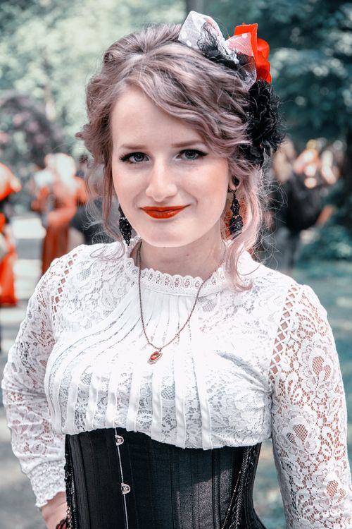 Free Portrait of a stylish woman in vintage attire with lace and corset outdoors in Leipzig, Germany. Stock Photo