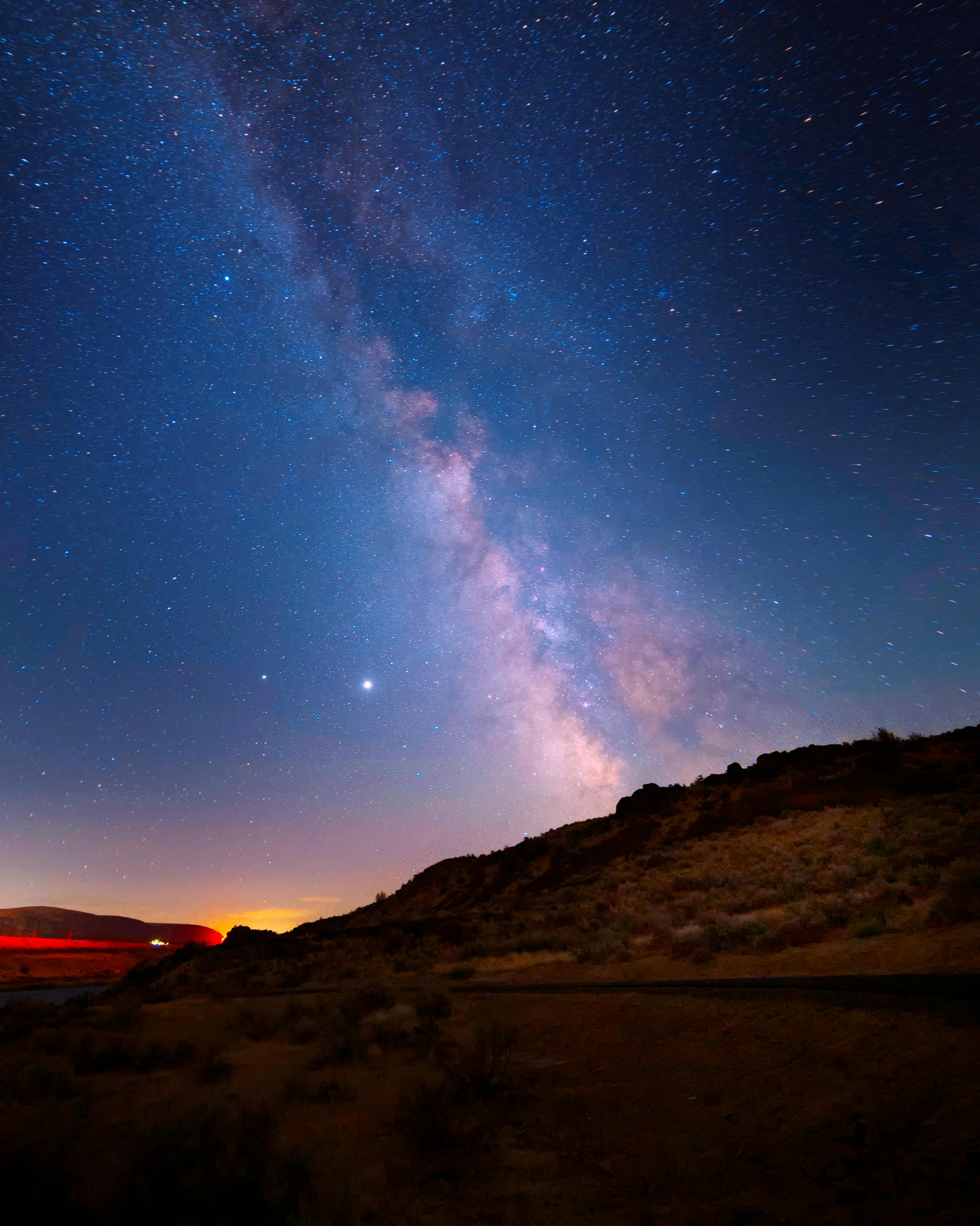 Beautiful Milky Way galaxy above scenic desert landscape at night, offering a breathtaking view of the stars.