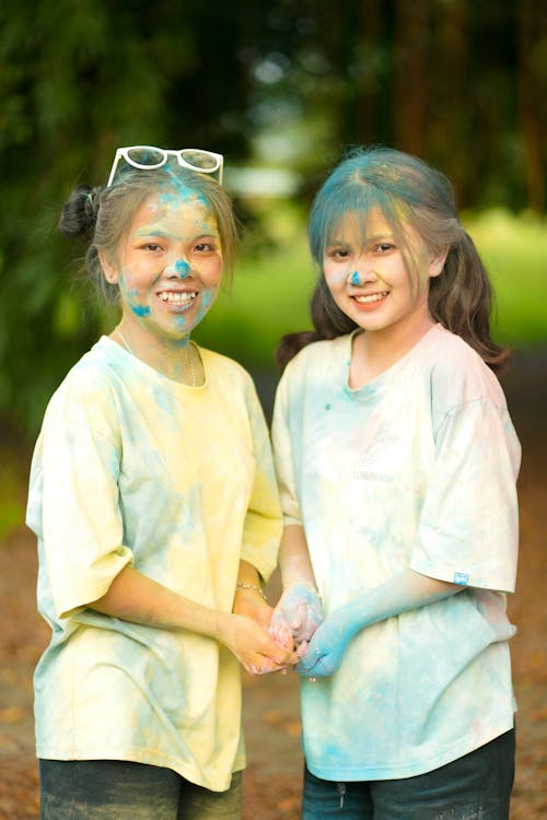 Two Girls Covered in Blue Powder